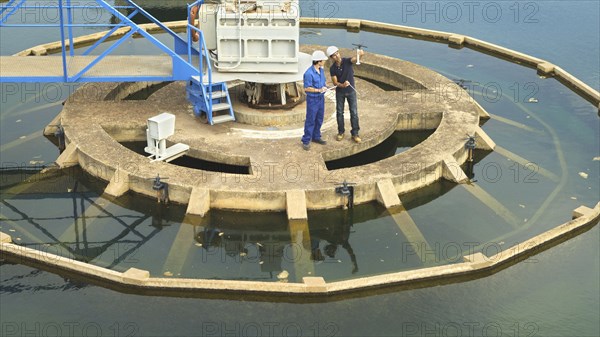 Hispanic workers checking water quality