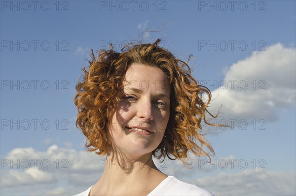A young red-haired woman outdoors