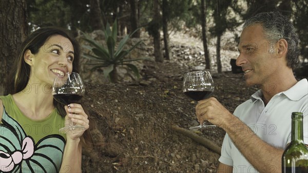 Couple drinking red wine in outdoors setting