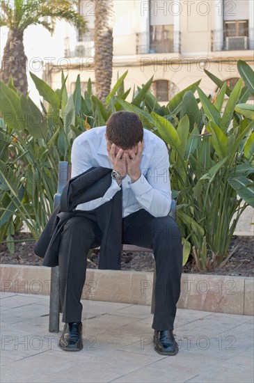 distraught man on park bench