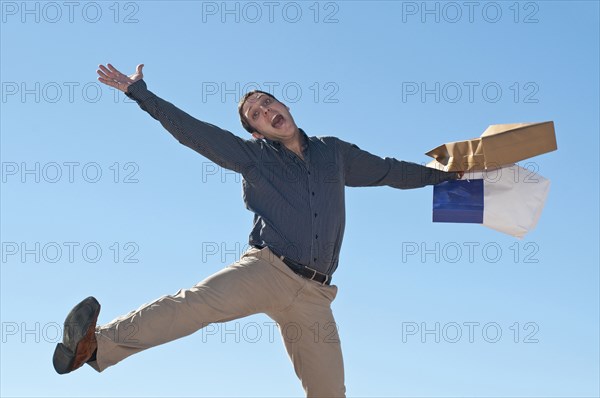 jumping man with shopping bags