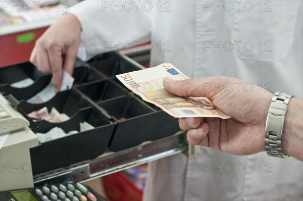 cash in hand of customer paying in supermarket