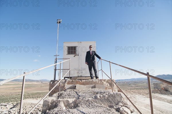 businessman in front of office container