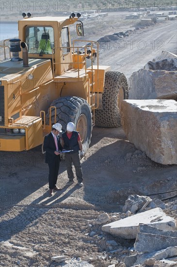 manager and worker in marble quarry