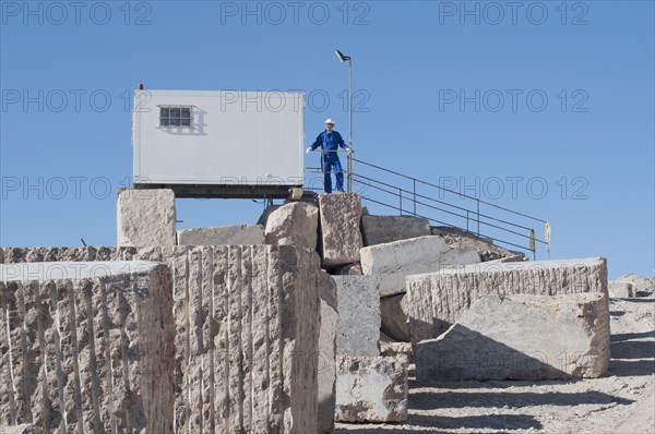 worker standing in front of office container