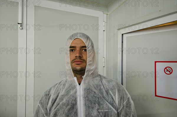 man in safety coverall in food processing plant