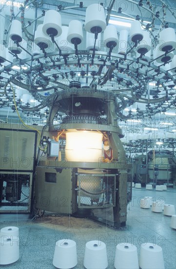 Man operating machine in textile factory