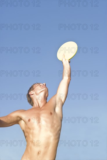 young man catching frisbee