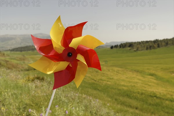 Windwheel on green rolling hills