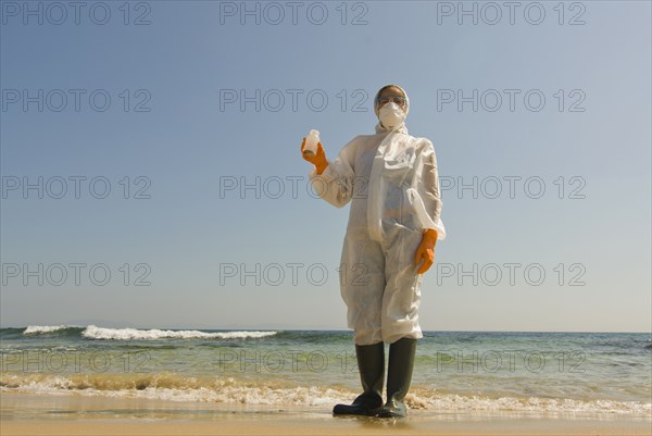 Woman in full-body protective clothing on beach