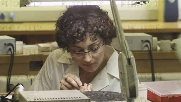 Female jeweller working on piece of jewellery