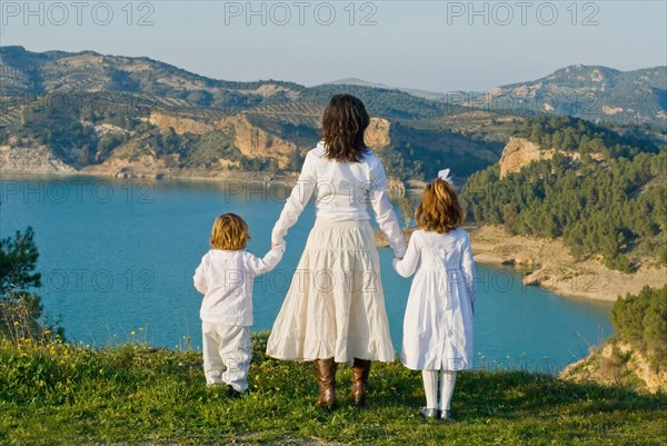 Spain Malaga mother and children looking at lake rear view