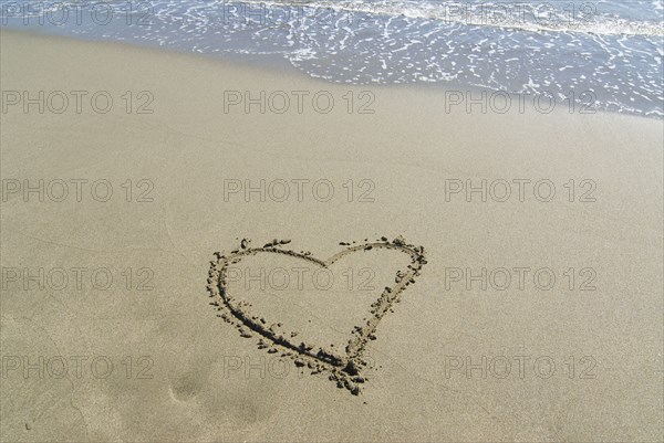 Spain Andalusia heart shape drawn in sand on beach