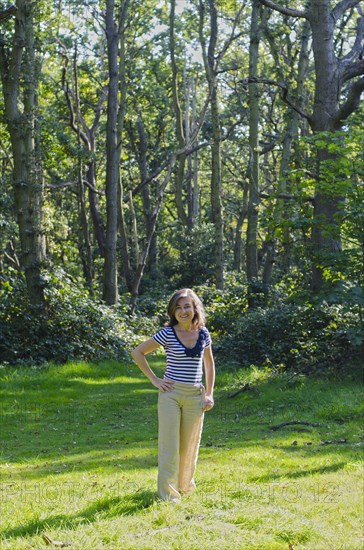 woman standing in clearing in forest