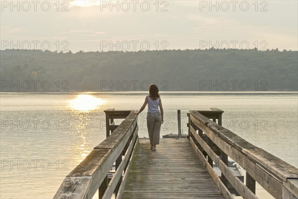 woman looking out to sea from jetty