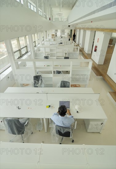 Man sitting in empty office elevated view