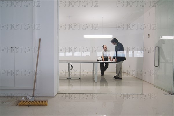 Two men in conference room of new office