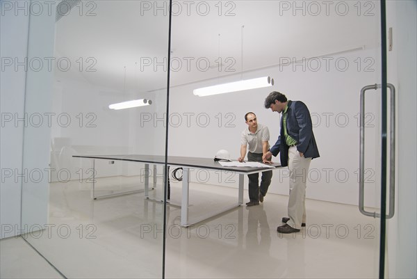 Two men in conference room of new office