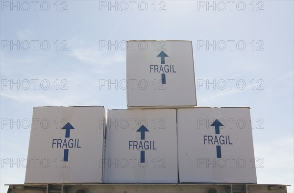 Removal boxes piled on crate low angle