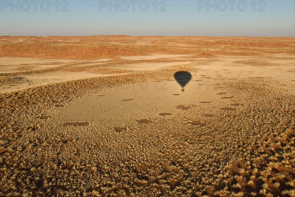 Namibia shadow of hot-air balloon above Namib Desert