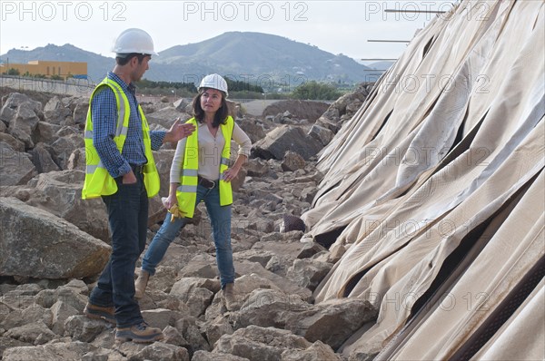 male and female engineers in construction site