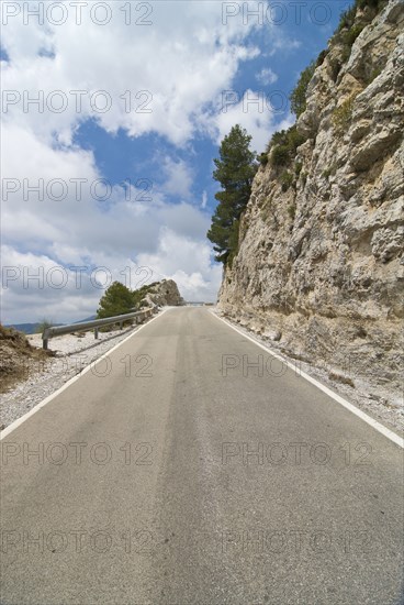 Mountain road running to vanishing point