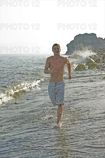 young man running in surf