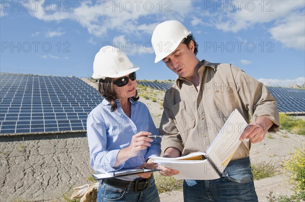 engineers looking at plans in solar plant