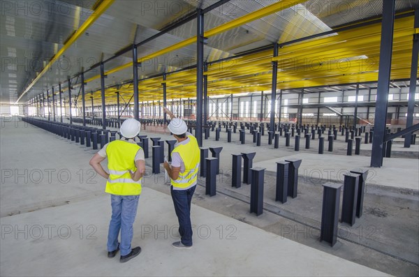 Workers examining warehouse