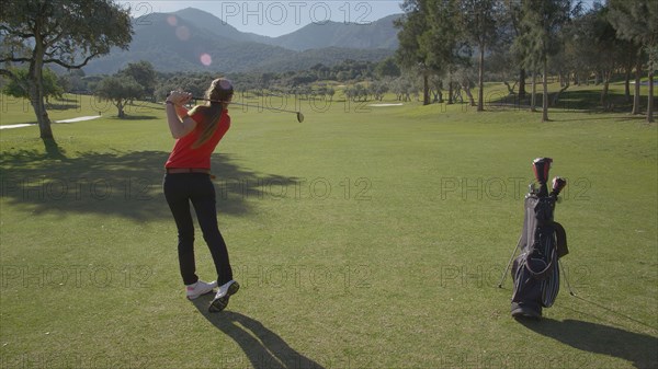 Caucasian woman playing golf on course