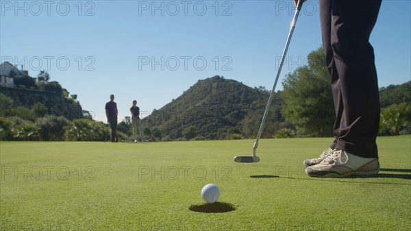 Caucasian woman putting on golf course