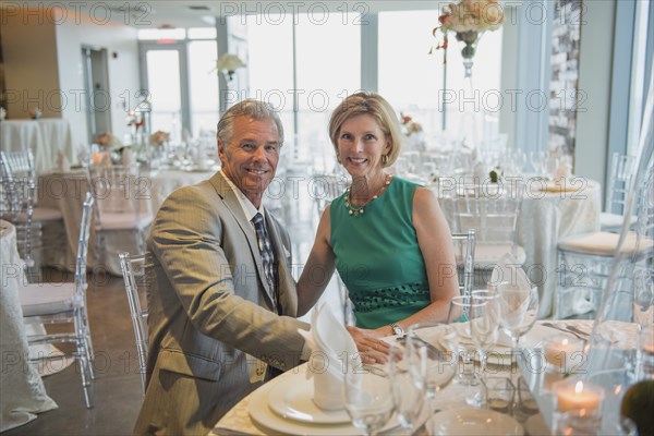 Caucasian couple smiling in empty restaurant