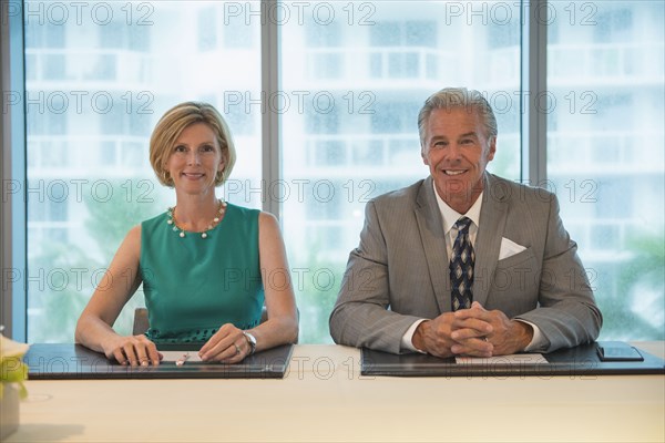 Caucasian business people smiling in meeting