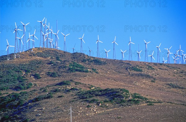 Wind turbines on hilltop in remote landscape
