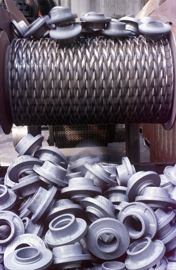 Plastic manufactured pieces on conveyor belt