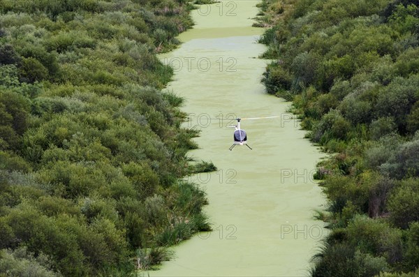 Aerial view of helicopter flying over remote river