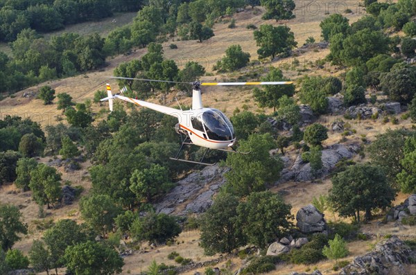 Aerial view of helicopter flying over remote landscape