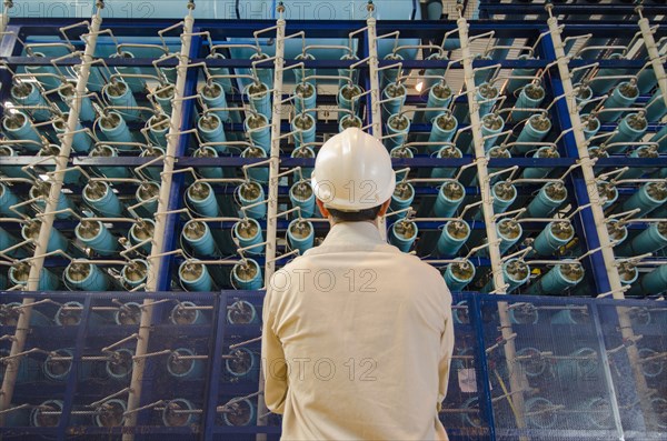 Hispanic technician examining power grid infrastructure