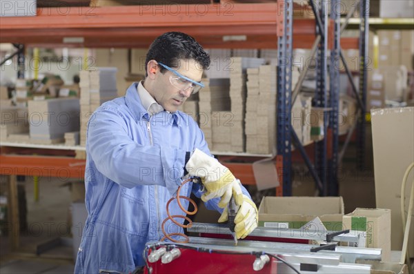 Hispanic technician working in factory