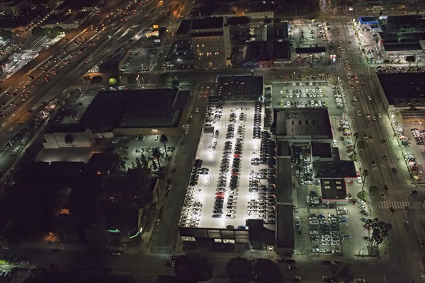 Aerial view of rooftop parking lot lit up at night