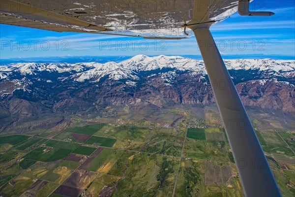 Aerial view of airplane wing over Cedarville