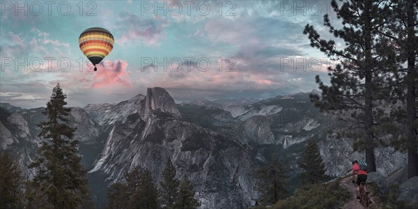 Hot air balloon floating over dramatic mountains