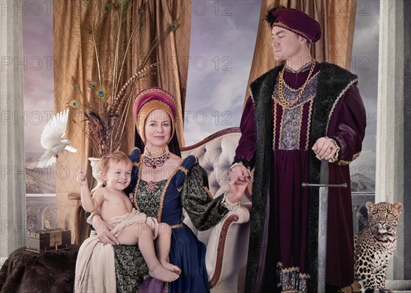 Medieval couple and child posing in living room