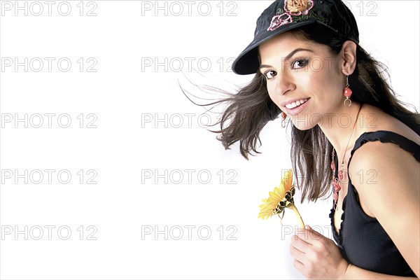 Smiling woman holding flower