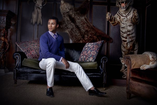 Man sitting in parlor with stuffed animals