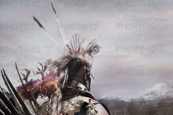 Hunter wearing traditional native headdress