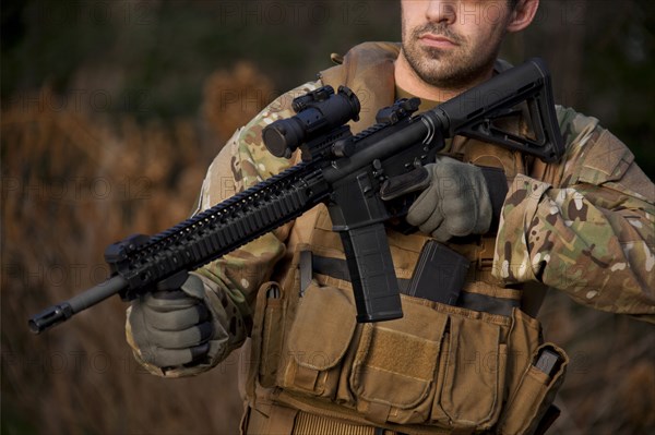 Soldier aiming automatic weapon during training