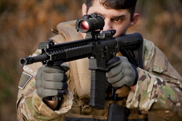 Soldier aiming automatic weapon during training