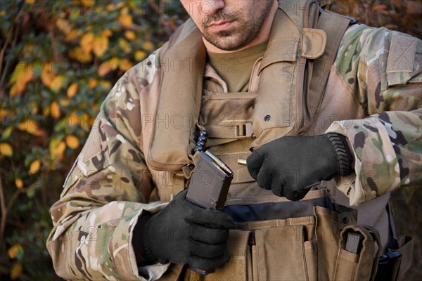 Soldier loading automatic weapon during training