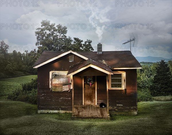 Dilapidated shack in rural field